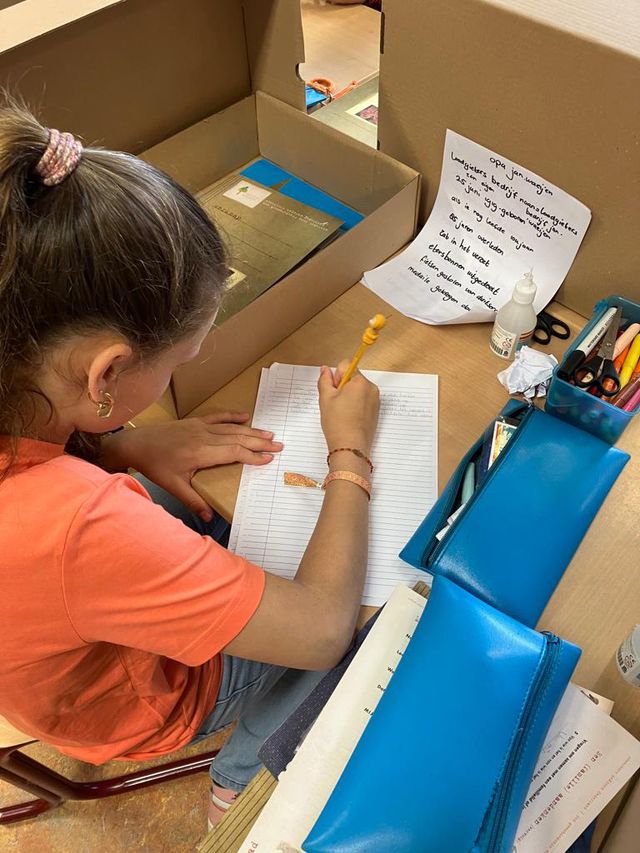 a student works on her family history museum box